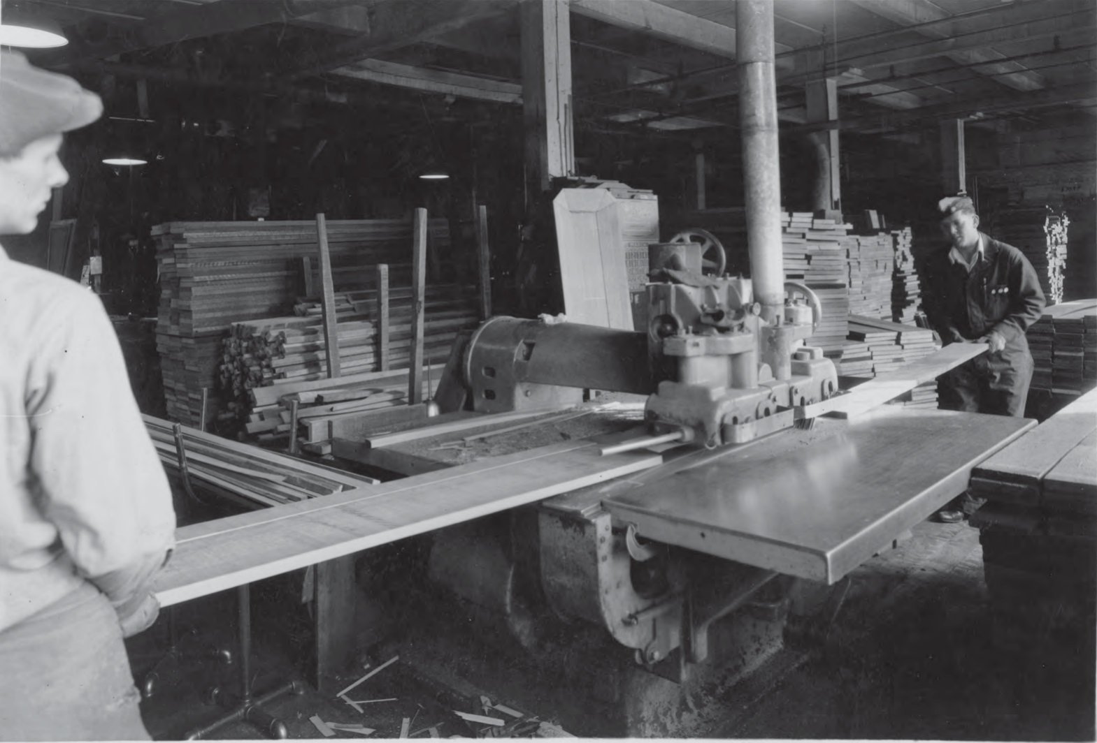 Historic photo of workers operating woodworking machinery at Northwestern Casket Company