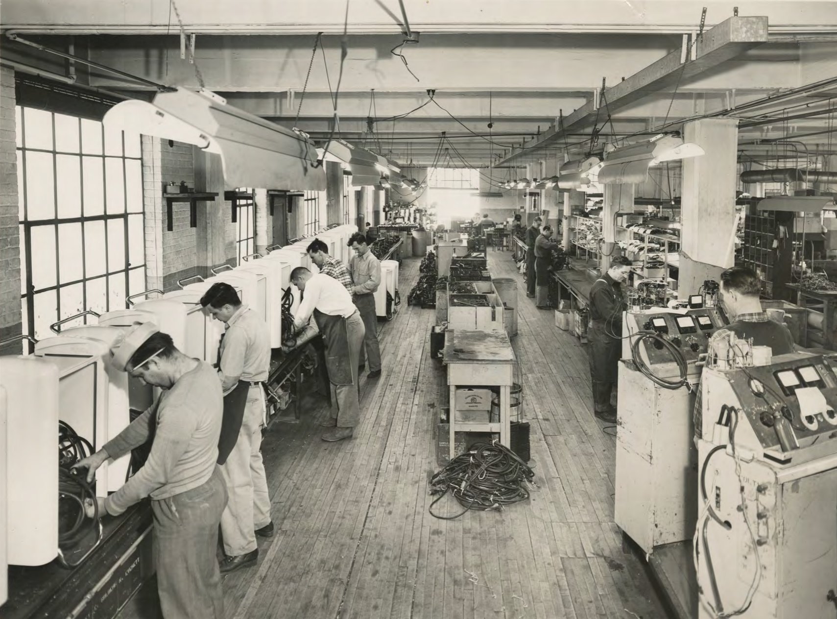Historic photo of workers at machines on the Franklin Transformer factory floor