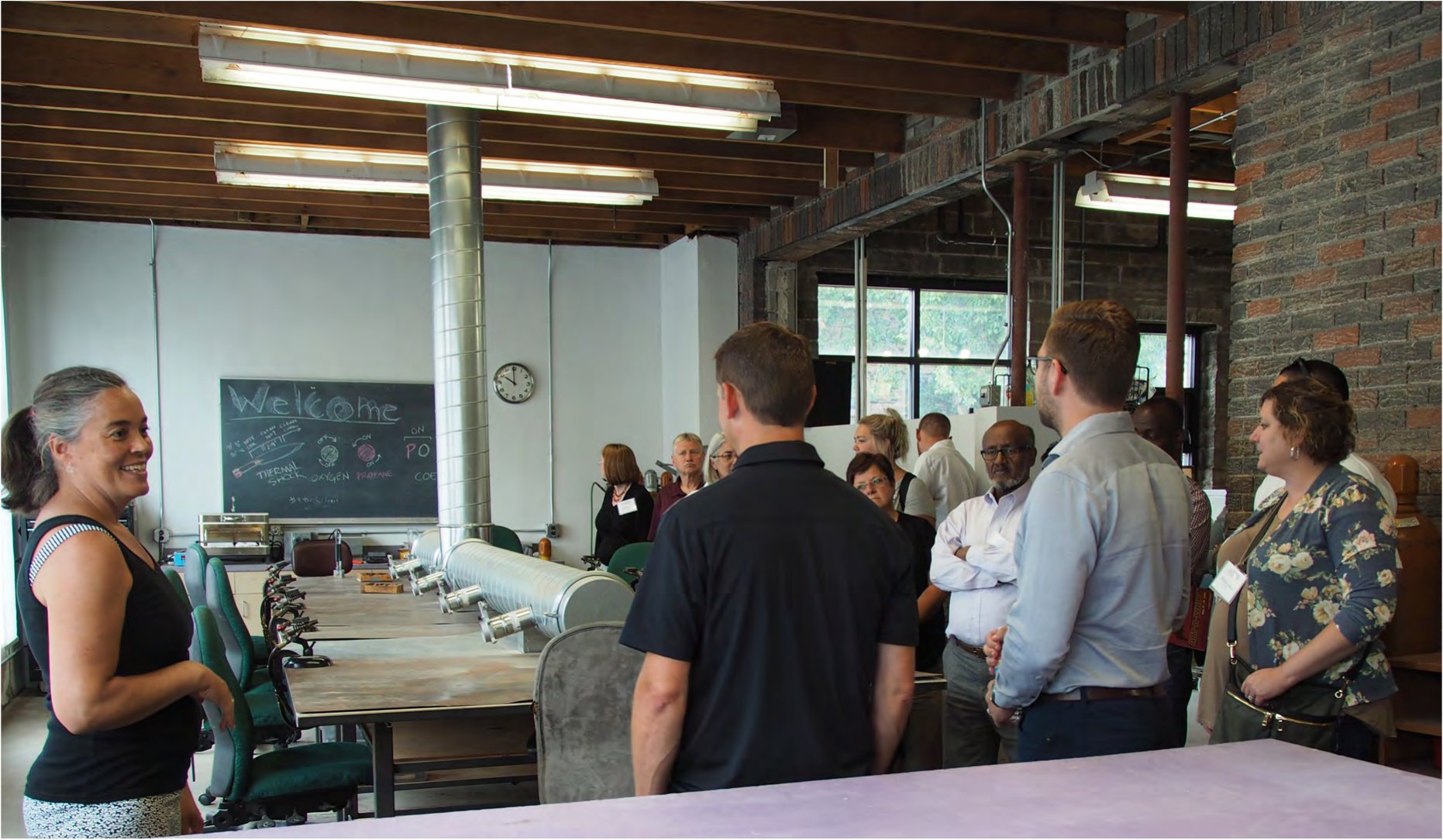 Group of visitors touring the Potekglass studio inside the Flux Arts Building