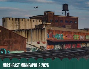 A bird flies over old industrial buildings with graffiti-covered walls beside train tracks, with the text NORTHEAST MINNEAPOLIS 2026 at the bottom.