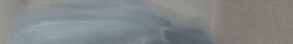 Abstract image of blurry, flowing grey and blue shapes.