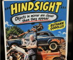 Art poster titled Hindsight featuring a photo of a person standing in front of a stack of old cars, with the text Objects in mirror are closer than they appear and the artists name, Ruthann Godollei.